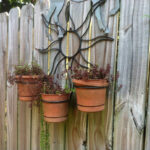 Pots decorate a fence