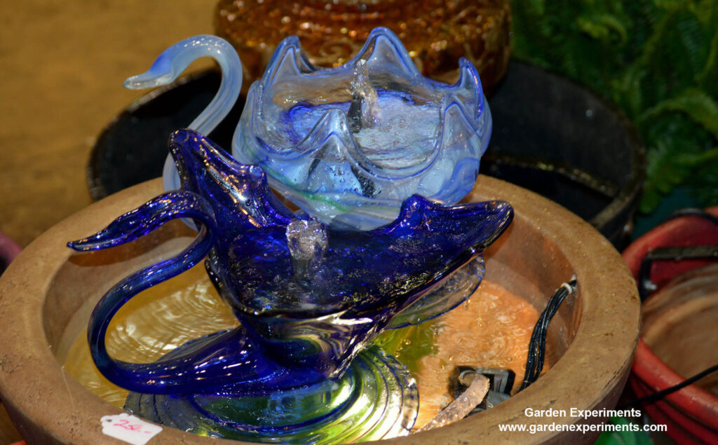 Glass swans made into a bird bath fountain