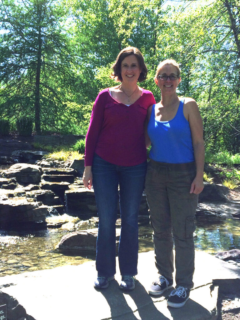 Me and my friend posing in front of the waterfall